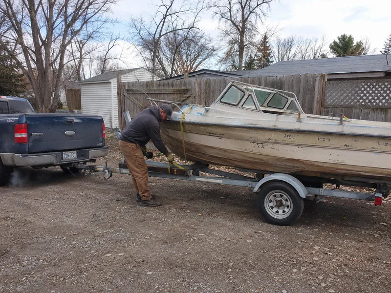 Boat removal hauler working in a yard for Trash My Junk contractor opportunities in Markham, Texas