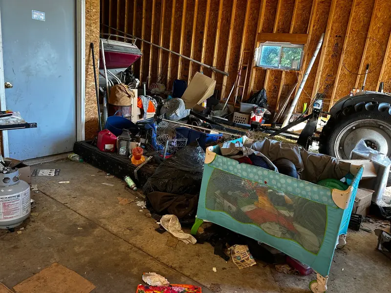 Truck loaded with black trash bags and household debris after a garage cleanout or estate cleanup